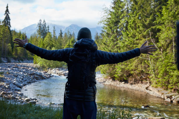 istock Young man in the mountains. Embracing Nature 871209348