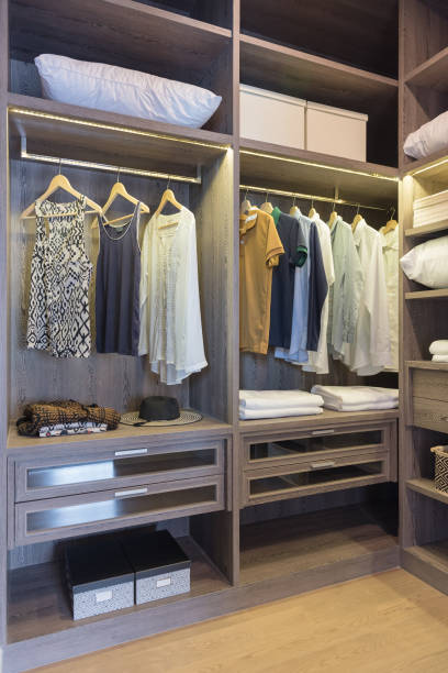 istock wooden wardrobe in walk in closet with clothes 871212286