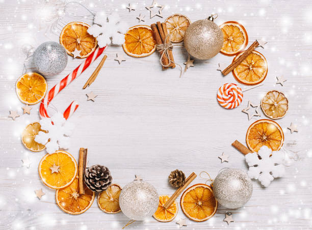 istock Christmas frame made from oranges. cinnamon, candies, various festive decor. copy space, free space for your text. close up 871213272