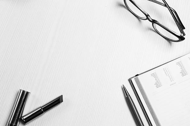stationery lying on the table black and white poster