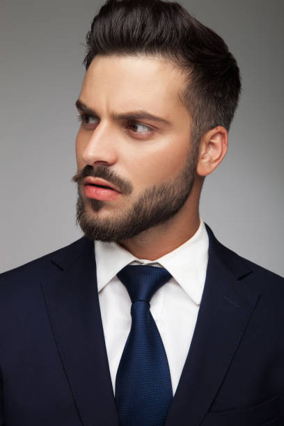 istock young bearded business man looks to side 871216918
