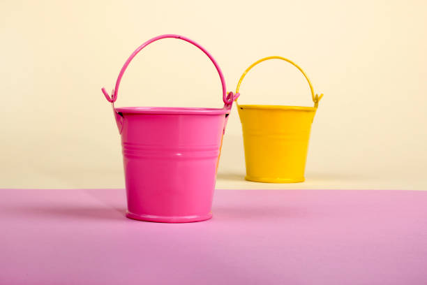 istock Pink and yellow bucket on a colored background 871217074