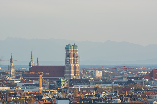 The Frauenkirche and city center of Munich, Germany with the Alps in the background