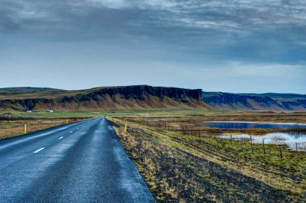 istock Empty Street with Icelandic Landscape during with misty mountain 871222778