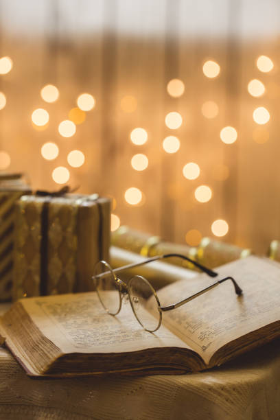 istock Holy bible book with eyeglasses 871223216