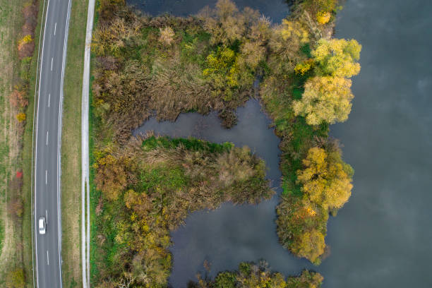 istock Riverbank and road - cloud reflection, aerial view 871224024