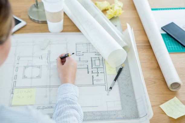 istock Unrecognizable female architect draws on a blueprint 871226508