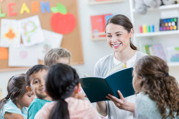 istock Young teacher pauses during group story time 871226646