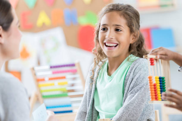 istock Elementary age girl takes verbal math quiz at school 871226660