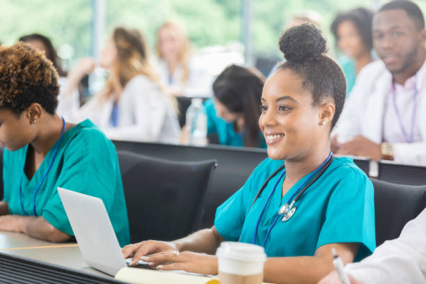 istock Beautiful female nursing student uses laptop during class 871227252