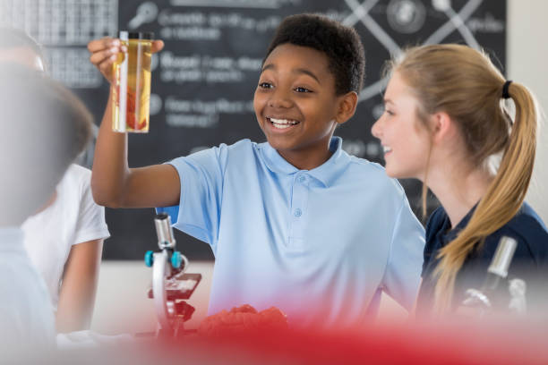 istock Preteen lab partners analyze specimen 871228178