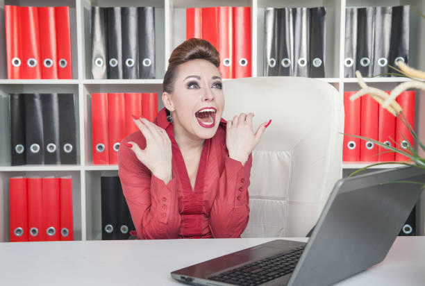 istock Laughing crazy business woman in office 871231714