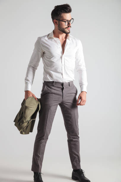 istock sexy young man standing and holding his coat 871231910