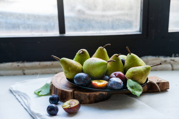 istock Studio shot plums and pears on plate heathy diet 871234548