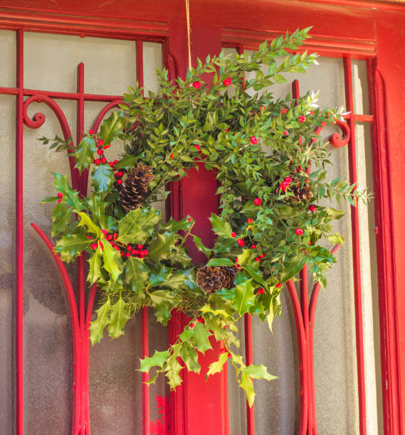 istock Christmas holly wreath on a red door 871234802