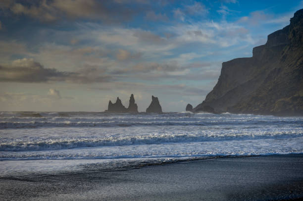 istock Black Beach and Sea-stacks in Vik Iceland with mountains waves a 871235708