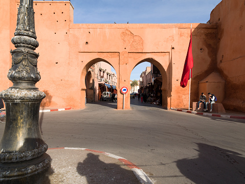 Horse and cars drawn carriage in front of one of the 19 gates of Marrakech, Bab Agnaou. It’s the entrance to the royal kasbah in the southern part of the medina of Marrakech.