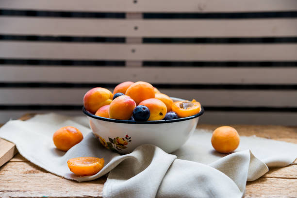 istock Studio shot of bowl with plums and apricots 871238782