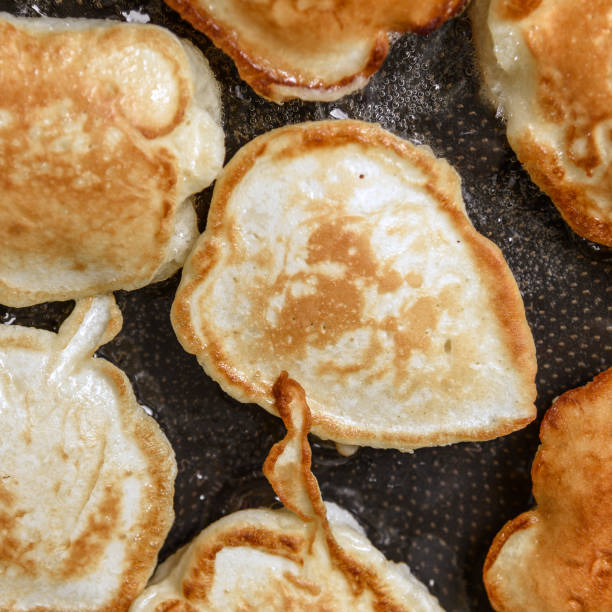 istock Golden pancakes frieding in a pan close-up 871238932