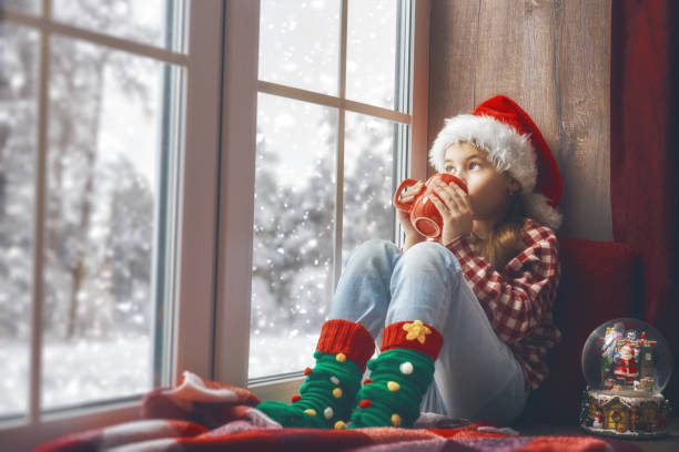 istock girl sitting by the window 871239286