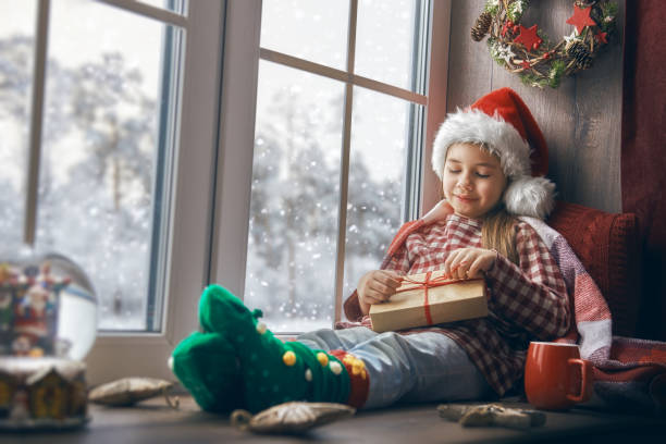 istock girl sitting by the window 871239316