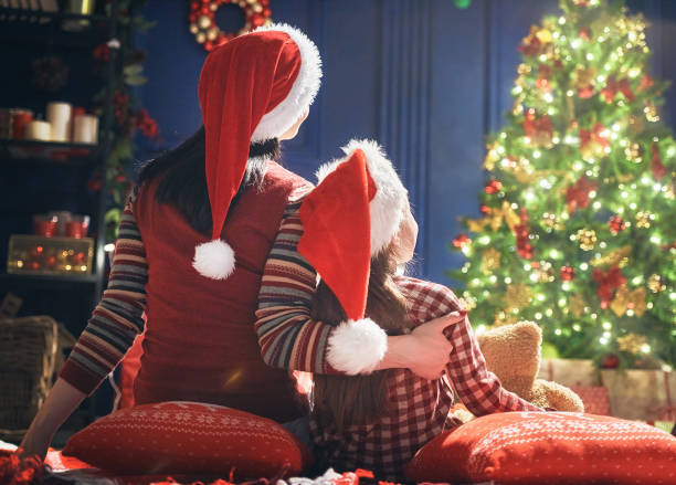 istock Mom and daughter near Christmas tree 871239410