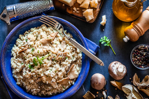 istock Risotto fungi porcini on dark kitchen table 871240096