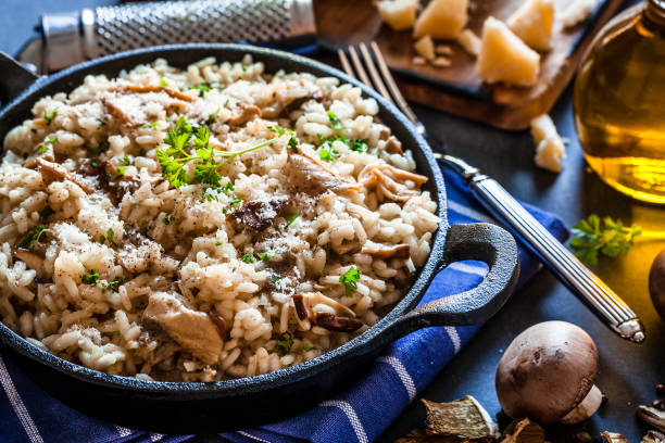 istock Risotto fungi porcini on bluish kitchen table 871240098