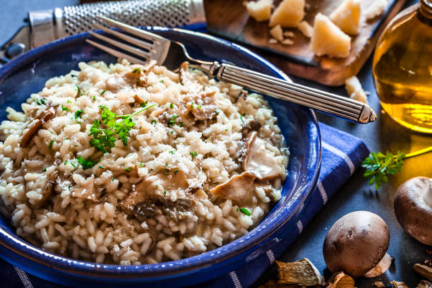 istock Risotto fungi porcini on dark kitchen table 871240498