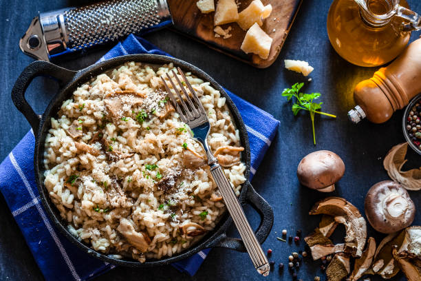 istock Risotto fungi porcini on bluish kitchen table 871242240