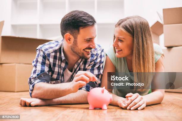 Couple Moving In Stock Photo - Download Image Now - Savings, Couple - Relationship, Piggy Bank