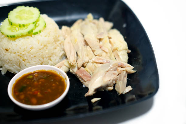 istock Hainanese chicken rice rice topped with chicken on black dish 871243814