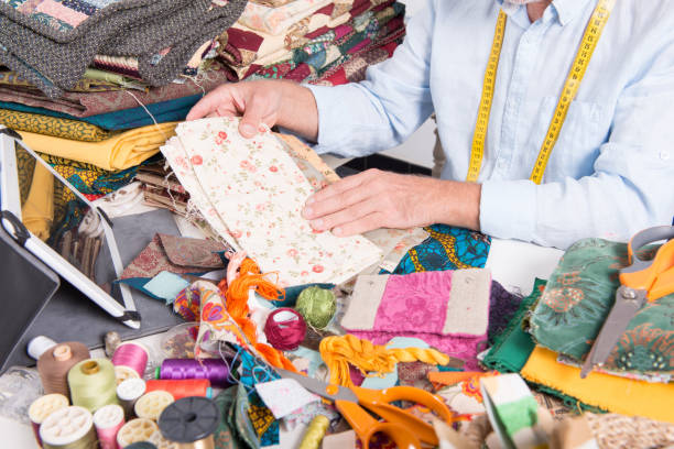 istock a mature man tailor choosing  some fabric 871247476