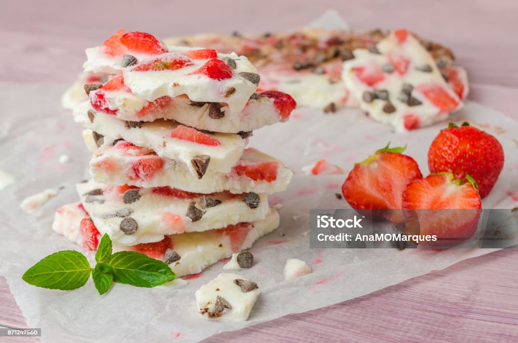 Homemade healthy frozen strawberry yogurt bark on rustic wooden background Yogurt Stock Photo