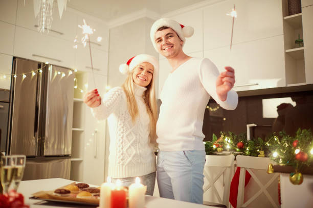 istock Couple with bengal lights for Christmas indoors . 871251238