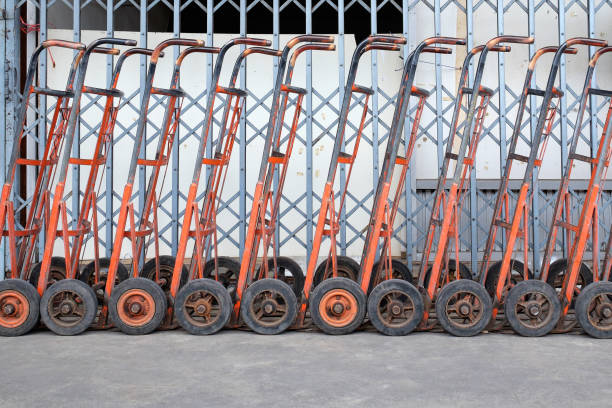 istock Old two wheel hand trucks and old iron door background. 871252204