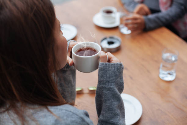 istock Young smiling woman drinking coffee in the morning 871254766