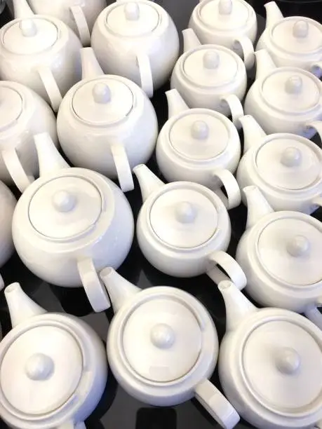 Many rows of white teapots