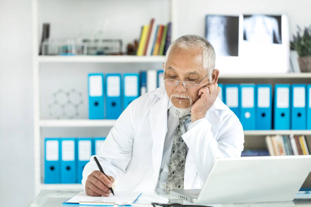 istock Medical specialist using laptop in cabinet 871254846