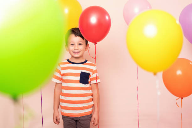 istock Cute child among colorful balloons. 871255522