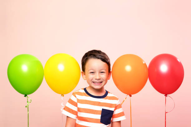 istock Cute child among colorful balloons. 871255620