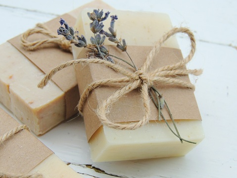 Handmade spa lavender soap on vintage wooden background. Soap making. Soap bars. Spa, skin care. Gift wrapping.