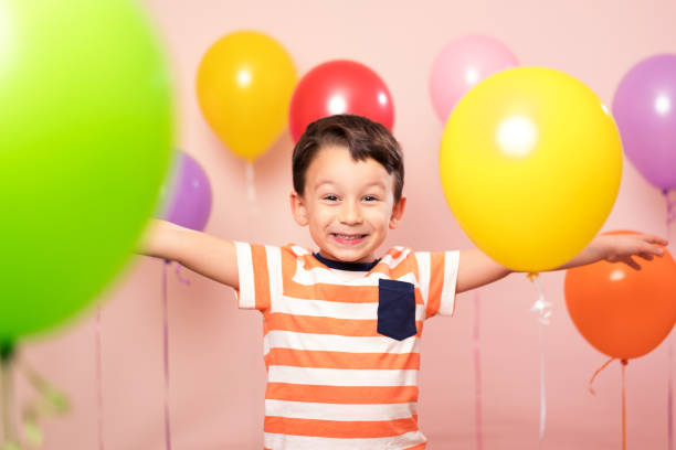 istock Cute child among colorful balloons. 871256006