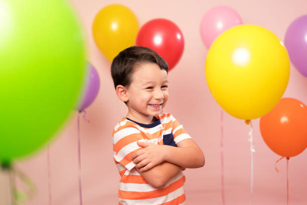 istock Cute child among colorful balloons. 871258476
