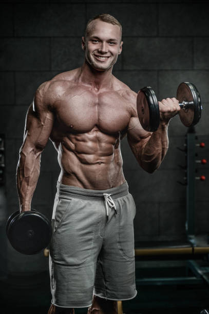 istock Attractive model young man training in gym 871259004
