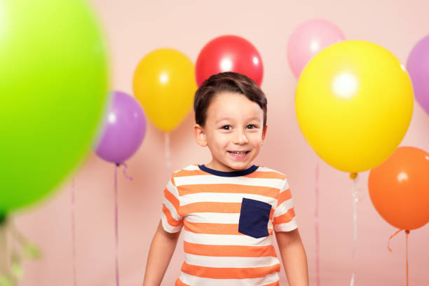 istock Cute child among colorful balloons. 871259146