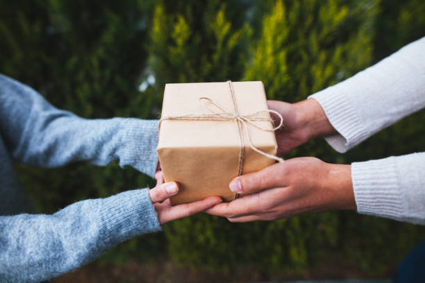 istock Man giving present to woman 871259842