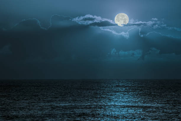 Blue moon light reflecting off ocean. Romantic twilight moonlight Blue moon light reflecting off ocean. Romantic twilight moonlight glistening off the surface of sea water. Lunar influence. arise and shine stock pictures, royalty-free photos & images