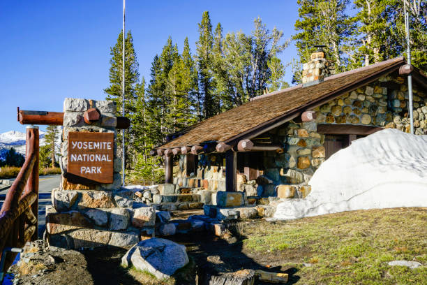 A sign at the north entrance of Yosemite National Park with beautiful The beautiful wilderness in the background.