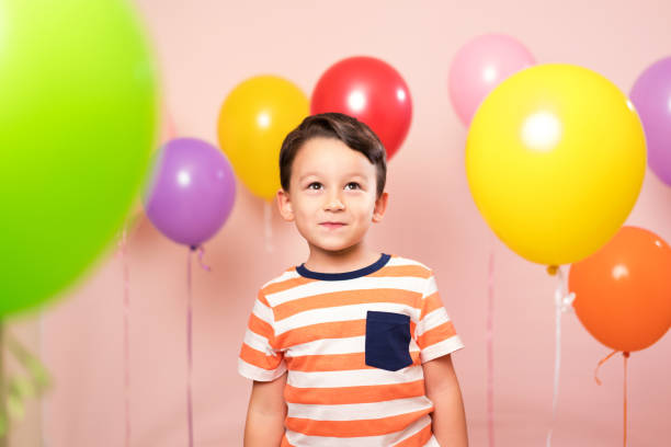 istock Cute child among colorful balloons. 871262248